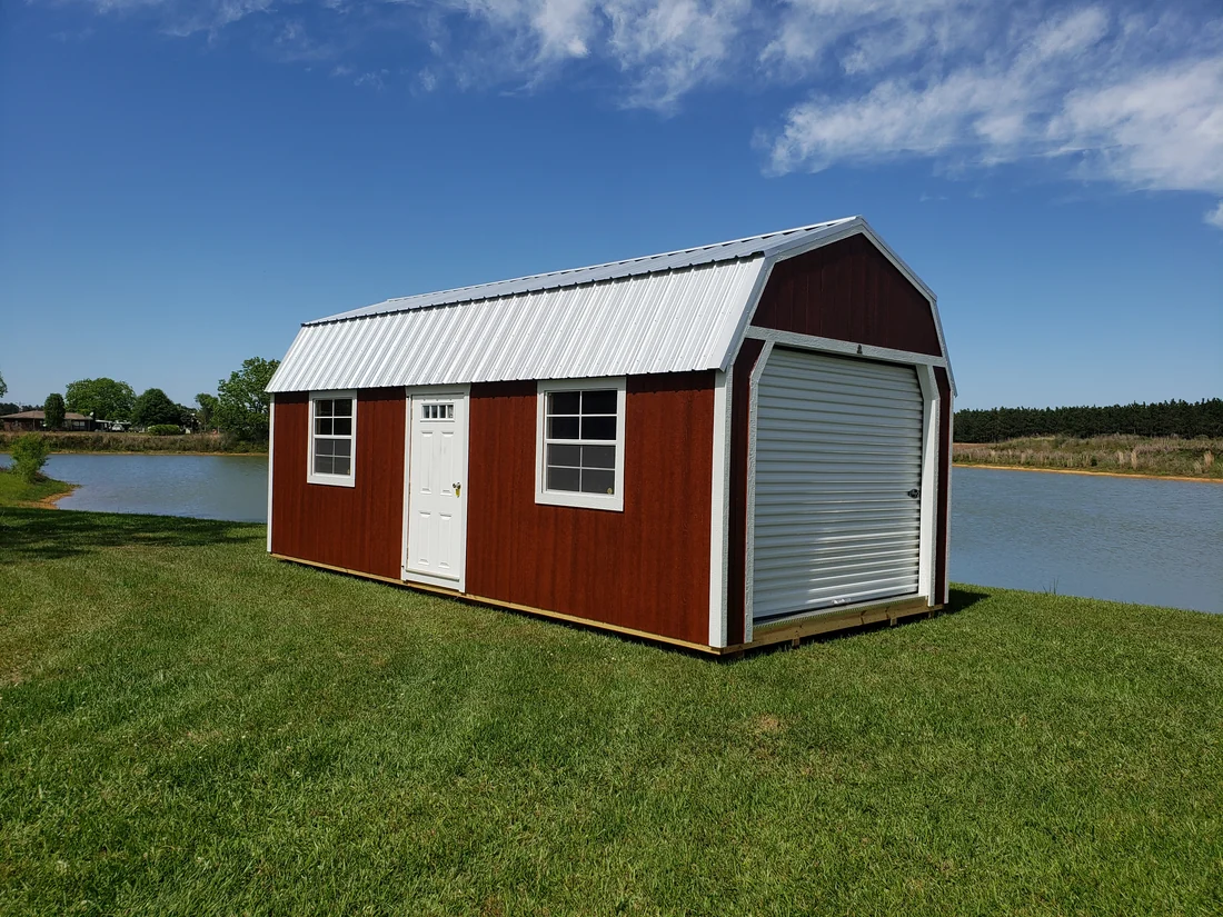 Red Circle E lofted garage with a roll-up garage door, entry door, and windows