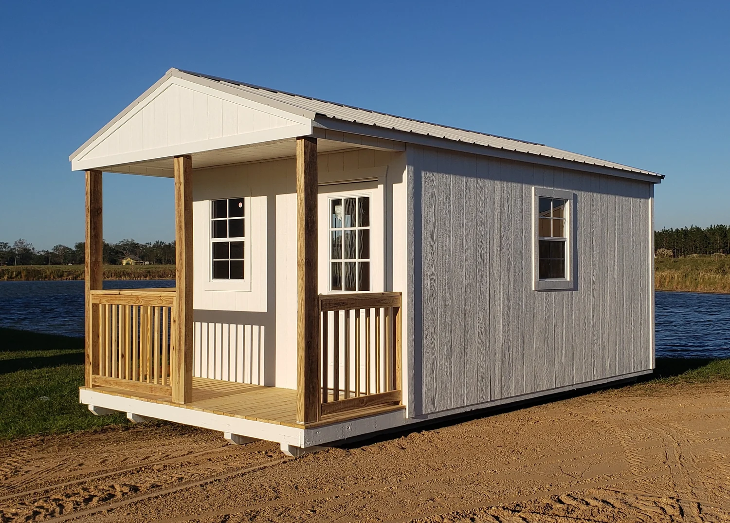 New gray Circle E cabin with a covered front porch and a metal roof