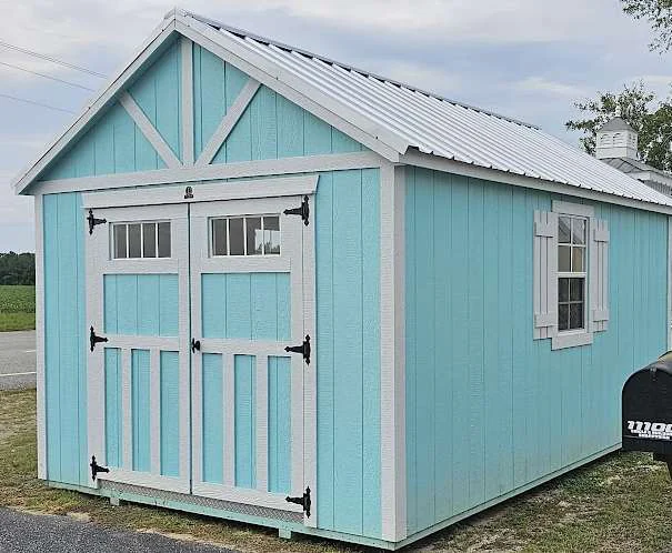 Teal Circle E storage shed with double doors and white trim
